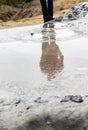 Reflection of a man in the lava of the muddy volcano in Buzau, Romania