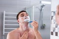 Reflection of a man shaving his chest with a razer in mirror Royalty Free Stock Photo