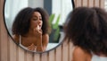 Reflection in mirror in bath home bathroom African American beauty female make-up apply natural smooth moisturize Royalty Free Stock Photo