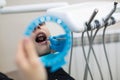 Reflection in the mirror mouth and teeth checkup of guy in a clinic Royalty Free Stock Photo