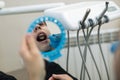 Reflection in the mirror mouth and teeth, dentist doing teeth checkup of guy in a dental room Royalty Free Stock Photo