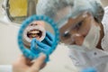 Reflection in the mirror mouth and teeth, woman dentist doing teeth checkup of boy Royalty Free Stock Photo