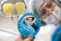 Reflection in the mirror mouth and teeth, dentist doing teeth checkup. Royalty Free Stock Photo