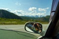 Reflection in the mirror of a riding white car of photographer w Royalty Free Stock Photo