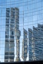 Reflection of modern city buildings in the glass facade of a tall building Royalty Free Stock Photo