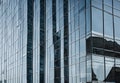 reflection of modern skyscrapers in windows of office building, during daylight Royalty Free Stock Photo