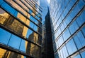 reflection of modern skyscrapers in windows of office building, during daylight Royalty Free Stock Photo
