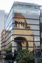 Reflection of the Monument to the Revolution on a tall building