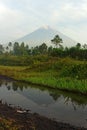 The reflection of Mount Semeru on a puddle