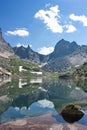 Reflection of mountain peaks in the lake in Sayan Mountains