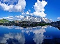 Reflection of Mountains and Clouds in Alpine Lake Royalty Free Stock Photo