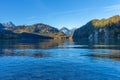 Reflection of mountains and shores on the surface of a lake in the Alps in the morning in autumn Royalty Free Stock Photo