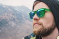 Reflection of the mountains in the sun mirror glasses of a hipster, a large portrait Royalty Free Stock Photo