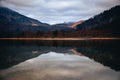 Reflection of mountainsides on the surface of freshwater on a clouded autumn day