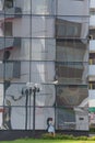 Reflection of a multi-storey building in the glass facade of a modern skyscraper