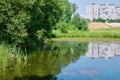 Reflection of multi-storey buildings in the pond Royalty Free Stock Photo