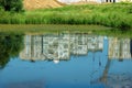 Reflection of multi-storey buildings in the pond Royalty Free Stock Photo