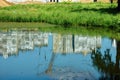 Reflection of multi-storey buildings in the pond Royalty Free Stock Photo