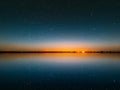 Blue bright starry sky on pink yellow sunset at sea water vawe reflection blurred light full moon moonlight  skyline  nebula natur Royalty Free Stock Photo