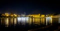 the reflection of the nighttime city in the lake