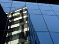 Reflection of office building on another office building glass wall in Bucharest Royalty Free Stock Photo