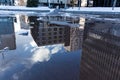 Reflection of office buildings in a puddle on the ground Royalty Free Stock Photo