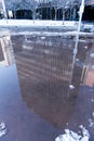 Reflection of office buildings in a puddle on the ground Royalty Free Stock Photo