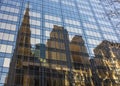 Reflection of old brown stone church and building in the glass o Royalty Free Stock Photo
