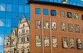 Reflection of an old building in new glass building. Old architecture versus modern reflected in glass. City of Liberec Royalty Free Stock Photo
