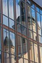 Reflection of an old church in the facade of a modern building Royalty Free Stock Photo