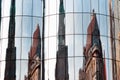 Reflection of an old church in the windows of a modern building Royalty Free Stock Photo