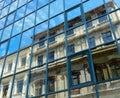 Reflection of the old house and the sky with clouds in the windows the new Royalty Free Stock Photo