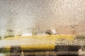 Reflection of old yellow car on wet asphalt during rain Royalty Free Stock Photo