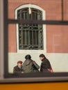 Reflection of older people talking in Venice