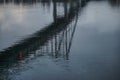 Reflection of a pedestrian bridge in the water surface of the Dnieper River in the center of the city of Kyiv Royalty Free Stock Photo