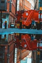 Reflection of people, fire truck and buildings on the water surface in the street