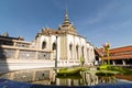 Reflection of Phra Viharn Yod temple in a pond with lotus flower at Grand Palace complex in Bangkok, Thailand