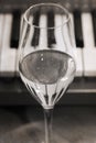 Reflection of piano keys in wine glass