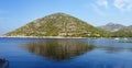 Reflection of picturesque hill in the sea in Croatia in bright summer day