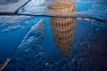 Reflection of Piza Tower in water after rain. Italy