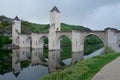 Reflection of the Pont Valentre bridge on the Lot river