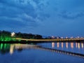 The reflection of the pontoon and pontoon in the water at night forms a beautiful picture.