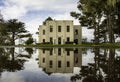 Reflection of a public works building in a large puddle Royalty Free Stock Photo