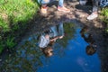 A reflection in a puddle - two sisters girls teenagers talking to each other in the Park. Nature. Royalty Free Stock Photo