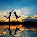 Reflection of Relax of two women standing and sunset silhouette Royalty Free Stock Photo