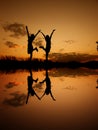 Reflection of Relax women standing and sunset silhouette Royalty Free Stock Photo