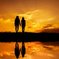 Reflection of Relax women standing and sunset silhouette Royalty Free Stock Photo