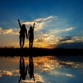 Reflection of Relax women standing and sunset silhouette Royalty Free Stock Photo