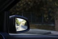 Reflection of the road in the car side rear-view mirror Royalty Free Stock Photo