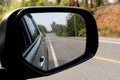 Reflection of the road in the side mirror of a car. Royalty Free Stock Photo
